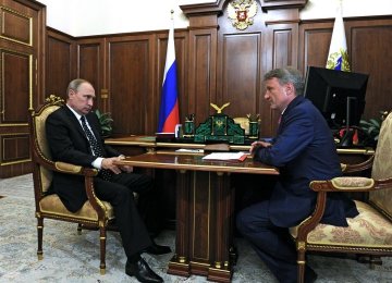 Vladimir Putin (L) and Herman Gref in a meeting at the Kremlin in Moscow (File photo)