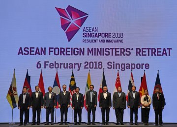 Foreign ministers pose for a group photo at the ASEAN Foreign Ministers’ Meeting retreat in Singapore on February 6.  