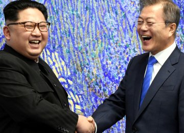 File picture of Kim Jong-un (L) and Moon Jae-in at the truce village  of Panmunjom, South Korea.
