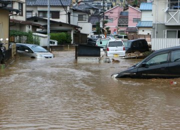 Floods and landslides swept the western part of Japan, leaving the government with $2.44 billion bill  to rebuild areas destroyed by the disasters.