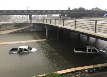 Vehicles half submerged in flood waters under a bridge in the aftermath of hurricane Harvey, in Houston, Texas, August 27.