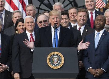 Donald Trump (C) joins with Senate Majority Leader Mitch McConnell, Vice President Mike Pence, Speaker of the House Paul Ryan and Sen. Tim Scott during a tax bill press conference on the South Lawn of the White House, on Dec 22.