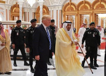 US President Donald Trump walks with Saudi Arabia’s King Salman bin Abdulaziz Al Saud after signing  a $110 billion arms deal in Riyadh, May 20.