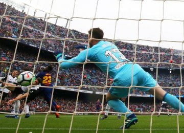 Barcelona’s Samuel Umtiti scores his side’s second goal past Valencia’s Neto.