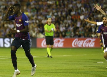 Ousmane Dembele (L) powers Barca past promoted Valladolid for second straight win.