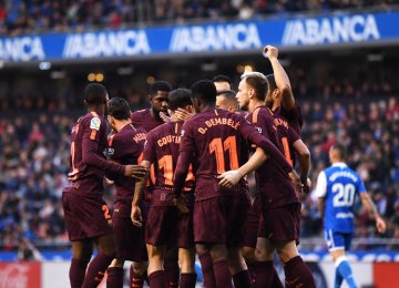 The Barcelona squad celebrates the victory.  