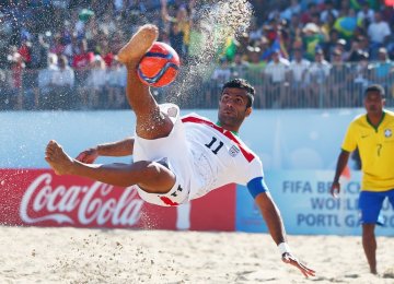 Mohammad Ahmadzadeh scores a goal with a bicycle kick during the FIFA Beach Soccer World Cup Portugal 2015 Group C match between Iran and Brazil.