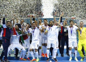 Iranian players and coaching team celebrate winning their second consecutive title. 