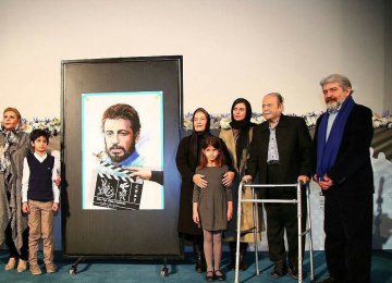 From left: Zahra Khoshkam, Mani Mosaffa, Ehteram Boroumand, Asal Mosaffa, Leila Hatami, Mohammad Ali Keshavarz and Omid Rouhani with the official poster of the festival depicting Ali Hatami