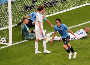 Uruguay’s Edinson Cavani celebrates scoring his team’s  third goal against Russia.