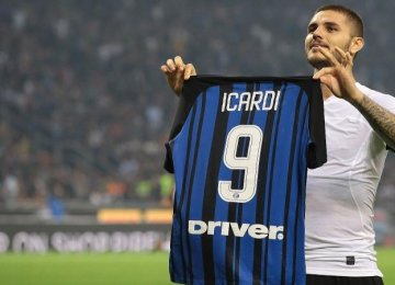 A Icardi shows his jersey to fans as he celebrates after scoring his 3rd goal against AC Milan.