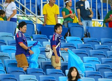 Japan supporters tidy up stadium following win over Colombia to cement reputation as best guests.