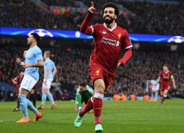 Liverpool’s Mohamed Salah rejoices scoring against Manchester City.