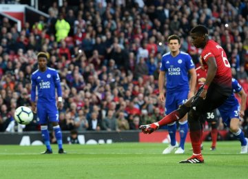 Paul Pogba shooting the ball to the goal from a spot-kick.