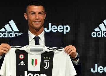 Cristiano Ronaldo holding Juventus jersey