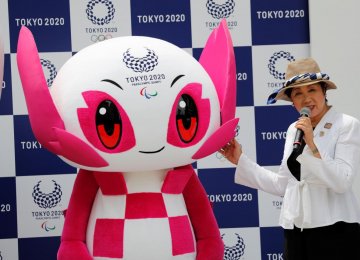 Tokyo Governor Yuriko Koike speaks next to Tokyo 2020 Paralympic mascot Someity during the mascot’s debut in Tokyo on Monday.