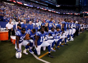 Indianapolis Colts players kneel during the playing of the national anthem at Lucas Oil Stadium last September.