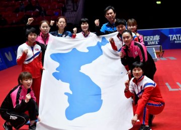 Korean players hold the unified  flag at the tournament.