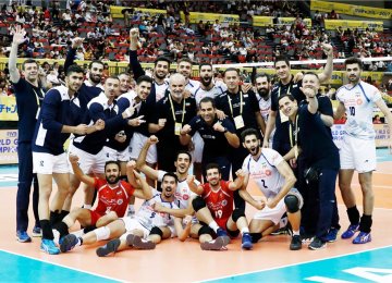 Iran players and coaching team celebrate after the victory