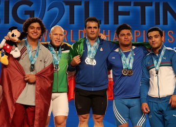 Sohrab Moradi (C) won three gold medals and Seyyed Ayub Mousavi (second R) won two bronze medals in the 94kg division.