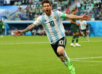 Lionel Messi celebrates scoring his teams’s first goal against Nigeria.