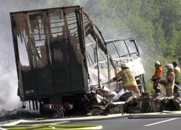 Firefighters at the site where a coach burst into flames after colliding with a lorry on a motorway near Muenchberg, Germany, in this still image taken from video on July 3. 