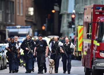 A group of police officers walk in London streets, on June 6, a few days after a terror attack on London Bridge and at Borough Market that killed seven people.