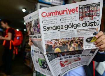 The Cumhuriyet opposition newspaper ran a headline focused on alleged vote violations: “A shadow fell over the ballot boxes”