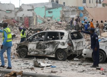 Soldiers secure the scene of an explosion in front of Dayah Hotel in  Mogadishu on Wednesday. (Feisal Omar/Reuters)