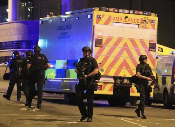 Armed police work after an explosion at the Manchester Arena in Manchester, England, on May 23.
