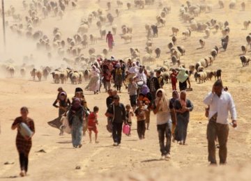 Displaced Yazidis flee IS toward the Syrian border  in August 2014. (File Photo)