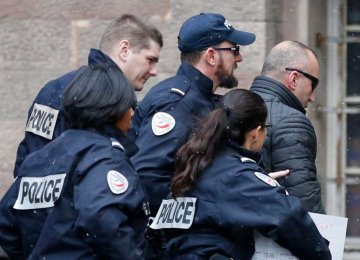 Former Kosovo prime minister Ramush Haradinaj,  is rushed by police officers inside the Colmar courthouse, eastern France, on Jan. 5.