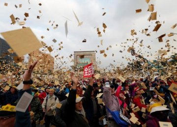 Protesters throw fake banknotes during the rally outside the Presidential Office in Taipei, Taiwan, on Jan. 22.