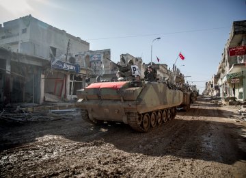 Turkish Army’s armored vehicles and tanks drive in the Syrian town of Kobani on Feb. 22, 2015. (File Photo)