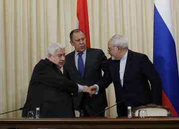 Foreign ministers Sergey Lavrov of Russia is flanked by Walid al-Muallem (L) of Syria and Mohammad Javad Zarif of Iran during a news conference in Moscow on April 14.