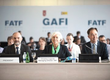 FATF President Juan Manuel Vega-Serrano (L) and IMF President Christine Lagarde (C) attended the plenary meeting in Valencia, Spain. 