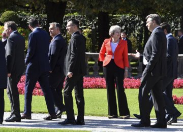 British Prime Minister Theresa May looks to passing  by heads of government after the family photo at the informal EU summit in Salzburg, Austria, Sept. 20.