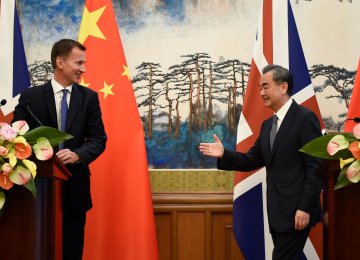 Britain’s Foreign Secretary Jeremy Hunt (L) and China’s Foreign Minister Wang Yi at a joint news conference  at the Diaoyutai State Guesthouse in Beijing, China, on July 30