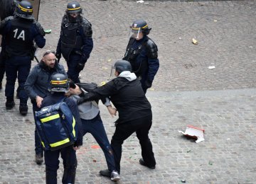 A screen shot from a video showing Alexandre Benalla wearing a police helmet and manhandling a protester in Paris in May.