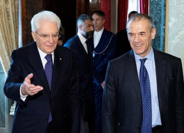 Former senior IMF official Carlo Cottarelli (R) arrives for a meeting with the Italian President Sergio Mattarella  at Quirinal Palace in Rome, Italy on May 28.