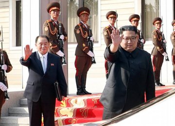 North Korean leader Kim Jong-un, standing next to former spy chief and senior official Kim Yong-chol, waves  to South Korean President Moon Jae-in after their summit at the truce village of Panmunjom, North Korea on May 26.