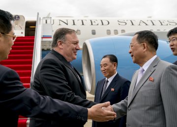 US Secretary of State Mike Pompeo (L) is greeted by North Korean Director of the United Front  Department Kim Yong-chol (C) and North Korean Foreign Minister Ri Yong-ho (R) as he arrives  at Sunan International Airport in Pyongyang on July 6.