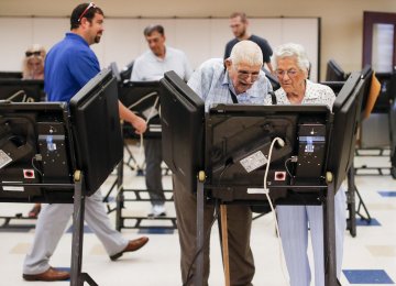 Voters cast their ballots among an array of electronic voting machines in a polling station at the Noor Islamic Cultural Center  in Dublin, Ohio, on August 7. 