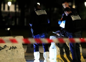 Police investigators work on the scene after seven people were wounded in knife attack downtown Paris, on Sept. 9.