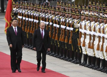 Russia’s President Vladimir Putin (R) reviews a military honour guard with Chinese President Xi Jinping during a welcoming ceremony outside the Great Hall of the People in Beijing on June 8.