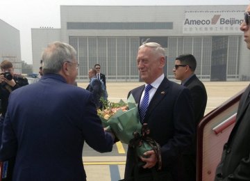 US Defense Secretary Jim Mattis (C) arrives at Beijing Capital International Airport in Beijing on June 26.