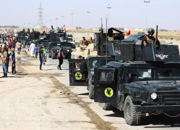Iraqi forces arrive in the first neighbourhood on the southern outskirts of Kirkuk on October 16. (Photo: AFP)