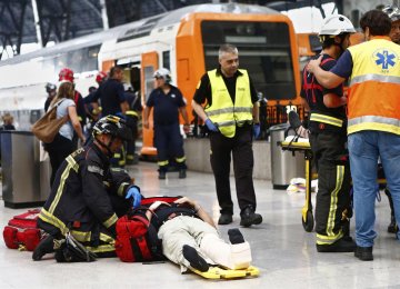 An injured passenger is attended to on the platform of a train station in Barcelona, Spain, July 28.