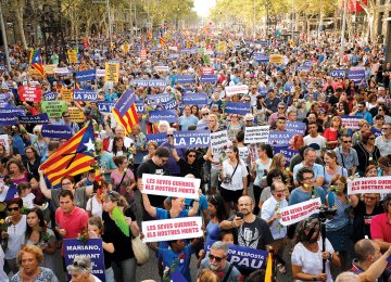 People hold placards during a march against terrorism which slogan will be #NoTincPor (I’m Not Afraid) in Barcelona on August 26.