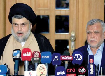 Moqtada al-Sadr speaks during a news conference with the Leader of the Conquest Coalition Hadi al-Amiri, in Najaf, Iraq on June 12.